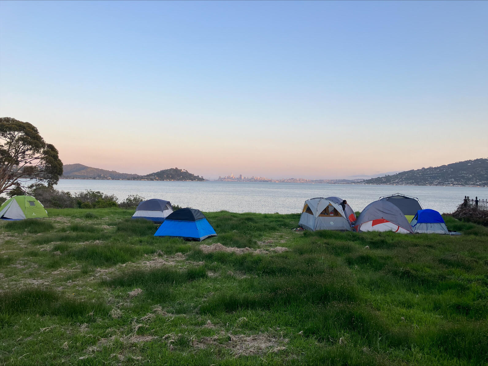 Tents in front of the San Francisco skyline.