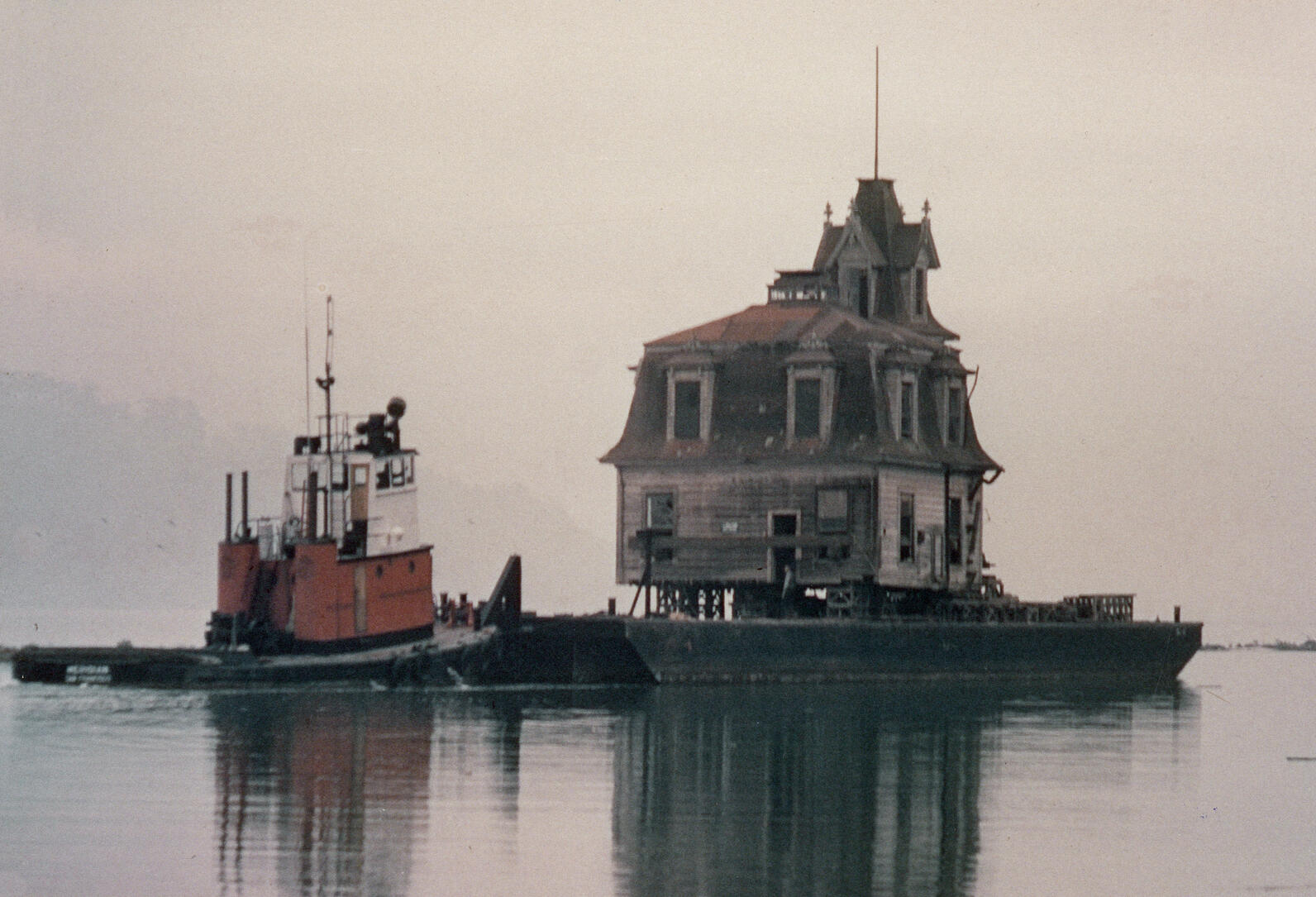 The Lyford House on a barge being moved from Strawberry Point to the beach at Richardson Bay.